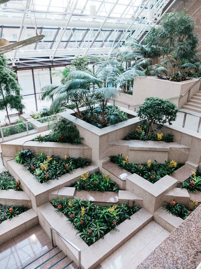Indoor terraced garden with tropical plants in a modern architectural setting.